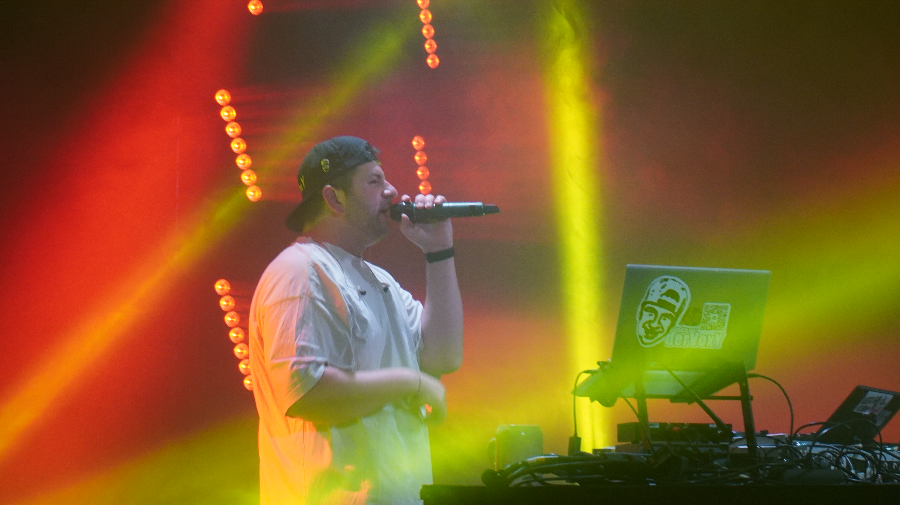 DJ Voxy live am DJ-Setup mit Mikrofon